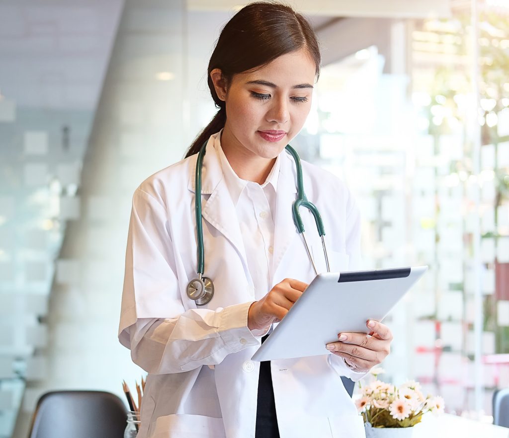 Female doctor reviewing chart on a clipboard